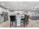 Open-concept kitchen with white cabinets, a center island, and bar stool seating at 13321 N White Cloud Ct, Camby, IN 46113