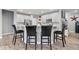 Stylish kitchen with white cabinets, counter seating and stainless steel appliances at 13321 N White Cloud Ct, Camby, IN 46113