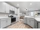 Modern kitchen with stainless steel appliances, white cabinets, and hardwood flooring at 13321 N White Cloud Ct, Camby, IN 46113