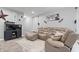 Cozy living room with a large sectional sofa, wood floors, and a contemporary rug at 13321 N White Cloud Ct, Camby, IN 46113