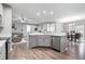 Open-concept living space with kitchen island, gray walls, and wood flooring at 13321 N White Cloud Ct, Camby, IN 46113