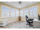 Bright office space with plantation shutters, neutral walls, and wood flooring at 13321 N White Cloud Ct, Camby, IN 46113