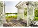 Idyllic backyard featuring a white pergola with a swing, garden, and a serene pond at 13815 Plantree Dr, Carmel, IN 46033