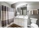 Bathroom featuring a double sink vanity, shower with curtain, and neutral paint at 13815 Plantree Dr, Carmel, IN 46033