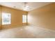 Large bedroom with neutral carpet, two windows, and a ceiling fan at 13815 Plantree Dr, Carmel, IN 46033
