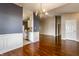 Dining room showcasing hardwood floors and decorative wainscoting with a view to the kitchen at 13815 Plantree Dr, Carmel, IN 46033