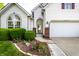 Charming home featuring a brick-accented entrance and manicured landscaping, enhancing its curb appeal at 13815 Plantree Dr, Carmel, IN 46033