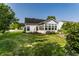 Well-maintained home exterior showcasing a sunroom, lush lawn, and inviting curb appeal at 13815 Plantree Dr, Carmel, IN 46033