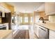 Bright kitchen featuring stainless steel appliances, white cabinets, and a view of the breakfast nook at 13815 Plantree Dr, Carmel, IN 46033