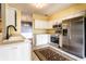 The kitchen features stainless steel appliances, white cabinets, and ample counter space at 13815 Plantree Dr, Carmel, IN 46033