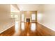 Spacious living room featuring hardwood floors, a fireplace, and seamless transition into the kitchen area at 13815 Plantree Dr, Carmel, IN 46033