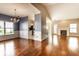 Open-concept living space featuring hardwood floors, a chandelier, and a fireplace at 13815 Plantree Dr, Carmel, IN 46033