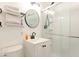 Modern bathroom featuring a toilet, vanity, sink, and glass-enclosed shower with a black faucet and towel bar at 1398 Clinton St, Noblesville, IN 46060