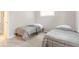 Cozy bedroom with two twin beds, soft carpet, and natural light from two windows creating a welcoming atmosphere at 1398 Clinton St, Noblesville, IN 46060
