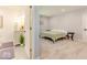 Inviting bedroom featuring neutral tones, carpeted floors, and a glimpse into an ensuite bathroom with a modern vanity at 1398 Clinton St, Noblesville, IN 46060