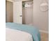 Cozy bedroom featuring a bed with a blue comforter, a closet with an open door, and a round mirror on the wall at 1398 Clinton St, Noblesville, IN 46060