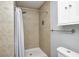 Tiled shower with shower curtain and showerhead in bathroom at 148 S 3Rd Ave, Beech Grove, IN 46107