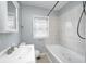 Bright bathroom with shower-tub combination, light tile, and sleek vanity at 148 S 3Rd Ave, Beech Grove, IN 46107