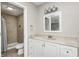 Bathroom featuring vanity with marble countertop and tiled shower with shower curtain at 148 S 3Rd Ave, Beech Grove, IN 46107