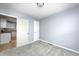 Bedroom featuring gray walls, plush gray carpet, white trim, and kitchen access at 148 S 3Rd Ave, Beech Grove, IN 46107