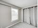 Cozy bedroom featuring a window, plush carpet, and a closet with curtains at 148 S 3Rd Ave, Beech Grove, IN 46107