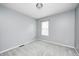 Cozy bedroom with neutral carpet, trim, and a window for natural light at 148 S 3Rd Ave, Beech Grove, IN 46107
