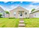 Charming home with a well-manicured lawn, stone walkway, and inviting curb appeal at 148 S 3Rd Ave, Beech Grove, IN 46107