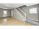 Hallway featuring wood flooring with carpeted stairs, a window and white trim at 148 S 3Rd Ave, Beech Grove, IN 46107