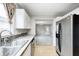 Bright kitchen featuring white cabinets and stainless steel appliances with hardwood flooring at 148 S 3Rd Ave, Beech Grove, IN 46107