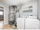 Functional laundry room with washer, dryer, and storage shelves at 148 S 3Rd Ave, Beech Grove, IN 46107