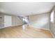 Spacious living room featuring hardwood floors, neutral paint, and a staircase at 148 S 3Rd Ave, Beech Grove, IN 46107