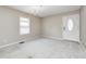 Bright living room featuring carpet and a traditional chandelier with ample natural light from a large window at 148 S 3Rd Ave, Beech Grove, IN 46107