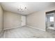Open-concept living room with view to bathroom featuring carpet and neutral walls at 148 S 3Rd Ave, Beech Grove, IN 46107