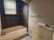 Bathroom featuring dark tile surround, tub, vanity and good natural light at 1624 E 30Th St, Indianapolis, IN 46218
