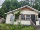 Charming single-story home with light siding, and mature trees in the background at 1624 E 30Th St, Indianapolis, IN 46218