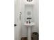 Clean powder room featuring a pedestal sink, decorative mirror and accents, and modern fixtures at 1816 Rosette Way, Indianapolis, IN 46202