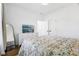 Bright bedroom featuring a large dresser with a tv and patterned bedding at 1816 Rosette Way, Indianapolis, IN 46202