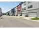 Street view of newly constructed townhomes featuring attached garages and modern exteriors at 1816 Rosette Way, Indianapolis, IN 46202