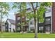 Modern townhouses with mixed siding and black accents on a lush green lawn with trees at 1816 Rosette Way, Indianapolis, IN 46202