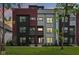 Modern townhouses with mixed brick, black, gray, and red siding under a vibrant evening sky at 1816 Rosette Way, Indianapolis, IN 46202