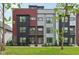 Modern townhouse with mixed brick, black, gray, and red siding and professional landscaping at 1816 Rosette Way, Indianapolis, IN 46202