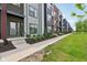Modern townhouses with mixed siding and black accents along a grassy walking path at 1816 Rosette Way, Indianapolis, IN 46202