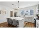 A well-lit modern kitchen featuring an island with seating and stainless steel appliances at 1816 Rosette Way, Indianapolis, IN 46202