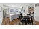 Bright modern kitchen with stainless steel appliances, an island, and a dining area with seating for four at 1816 Rosette Way, Indianapolis, IN 46202