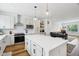Open-concept kitchen with a large center island, pendant lighting, and views into the living area at 1816 Rosette Way, Indianapolis, IN 46202