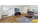 Open-concept living room with wood floors, a gray sectional, and a flat screen television at 1816 Rosette Way, Indianapolis, IN 46202