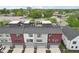 Drone shot showcasing modern townhomes with rooftop decks, sleek design, and integrated garage spaces at 1816 Rosette Way, Indianapolis, IN 46202