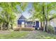 A backyard view with a small deck, well-maintained lawn, and a blue house at 1822 Howard St, Indianapolis, IN 46221