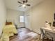 Bedroom features hardwood floors, a ceiling fan, and natural light at 1822 Howard St, Indianapolis, IN 46221