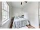 Bright bedroom features wood floors and large window at 1822 Howard St, Indianapolis, IN 46221
